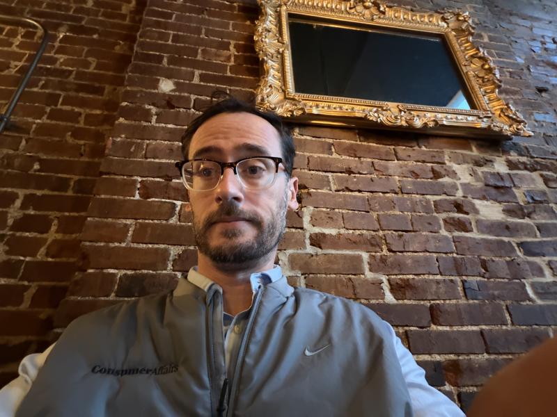 Polite Society exposed brick dining room with a gilded mirror